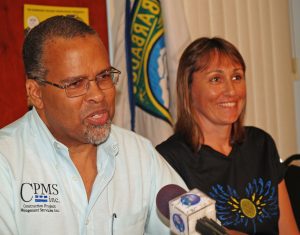 Craig Archer (left), president of the Barbados Squash Association, delivers remarks during yesterday’s press conference at the Barbados Olympic Centre. Looking on is local squash queen Karen Meakins, the reigning 14-time national champion. 